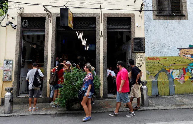 People arrive to eat the Brazilian traditional dish feijoada (black bean and meat stew) at the Bar do Mineiro in Rio de Janeiro, Brazil, March 24, 2016. (Photo by Sergio Moraes/Reuters)