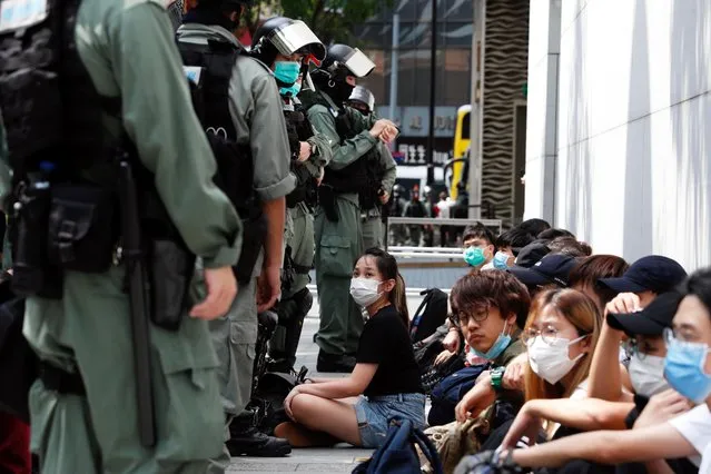 Anti-government demonstrators are detained by riot police during a protest at Causeway Bay as a second reading of a controversial national anthem law takes place in Hong Kong, China on May 27, 2020. (Photo by Tyrone Siu/Reuters)