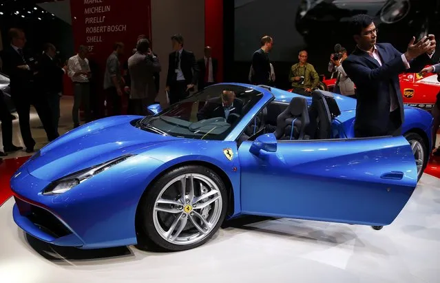 A visitor makes a selfie in front of a Ferrari car during the media day at the Frankfurt Motor Show (IAA) in Frankfurt, Germany, September 15, 2015. (Photo by Kai Pfaffenbach/Reuters)