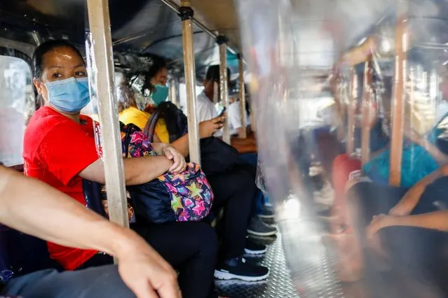 Passengers wearing masks for protection against the coronavirus disease (COVID-19) are seated in between plastic barriers to maintain social distancing in a jeepney, in Quezon City, Metro Manila, Philippines, July 3, 2020. (Photo by Eloisa Lopez/Reuters)