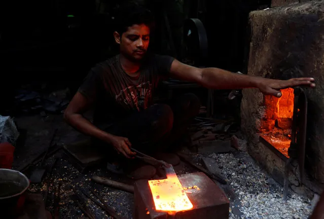 A worker forges a butcher’s knife at a workshop in Karachi, Pakistan, July 20, 2016. (Photo by Akhtar Soomro/Reuters)