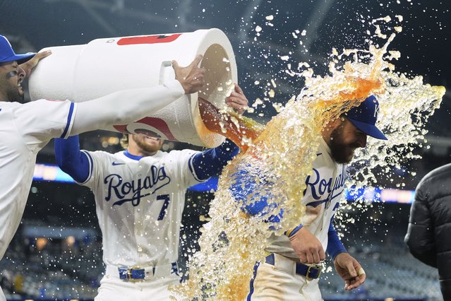 Kansas City Royals' Kyle Isbel is doused by MJ Melendez, left, and Bobby Witt Jr. (7) after a baseball game against the Minnesota Twins, Monday, April 7, 2025, in Kansas City, Mo. (Photo by Charlie Riedel/AP Photo)