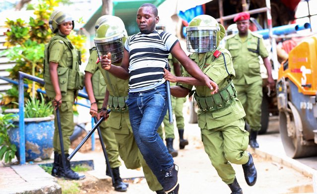 Tanzania police officers detain a supporter of the opposition leader and former presidential candidate of CHADEMA party Tundu Lissu, near the Kisutu Residents Magistrate Court in Dar es Salaam, Tanzania on April 24, 2025. (Photo by Emmanuel Herman/Reuters)