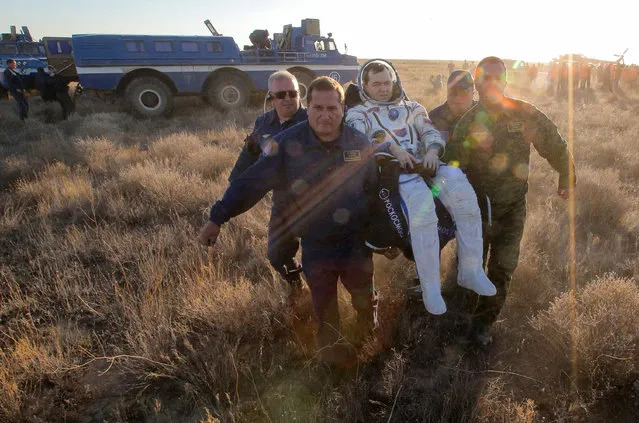 Ground personnel carry the International Space Station (ISS) crew member Oleg Skripochka of Russia after landing near the town of Zhezkazgan (Dzhezkazgan), Kazakhstan, September 7, 2016. (Photo by Maxim Shipenkov/Reuters)