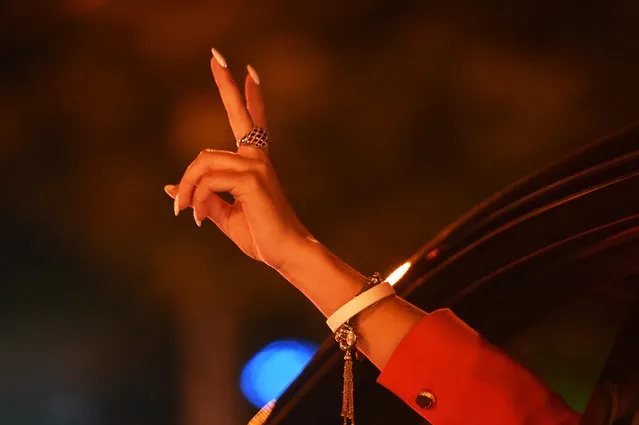 A woman wearing a white bracelet – a symbol of the opposition – gestures from inside a car during a rally of opposition supporters, who accuse strongman Alexander Lukashenko of falsifying the polls in the presidential election, in Minsk on August 11, 2020. (Photo by Sergei Gapon/AFP Photo)
