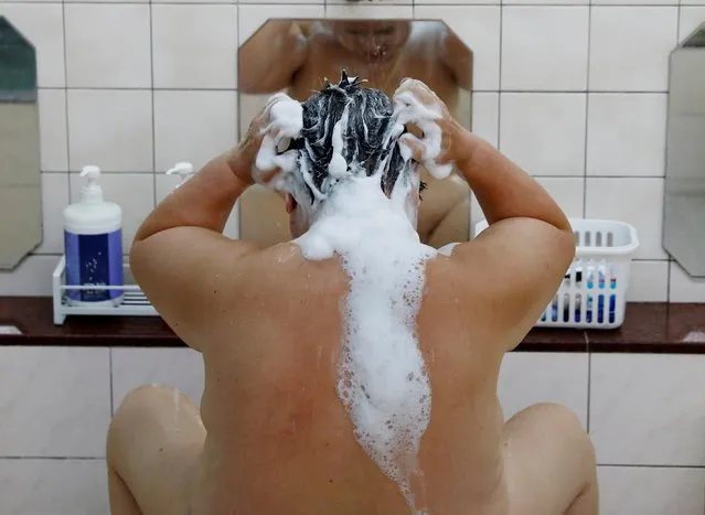 A customer washes his hair at public bathhouse “Daikoku-yu” in Tokyo, Japan on July 1, 2020. The government deemed Japan's few remaining bathhouses as critical for public hygiene so it requested they stay open, while at the same time encouraging people to stay at home during a state of emergency to prevent the spread of COVID-19 which has killed around 1,000 Japanese. (Photo by Kim Kyung-Hoon/Reuters)