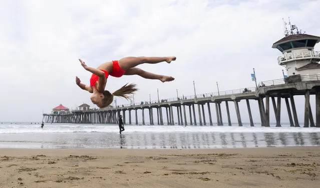 A student works on her skills during an acrobatics class near the pier in Huntington Beach, CA on Monday, August 17, 2020. Instructors at the Orange County Performing Arts Academy decided to bring the class to the beach from Anaheim Hills to beat the heat and give the students an end of the summer treat. (Photo by Paul Bersebach/The Orange County Register via AP Photo)