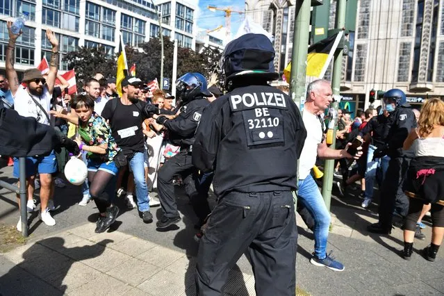 Participants of a demonstration against the Corona measures break through a police chain at the corner of Friedrichstraße/Reinhardtstraße in Berlin, Germany on August 29, 2020. (Photo by Bernd Von Jutrczenka/dpa)
