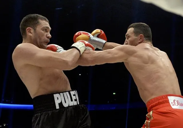 Ukrainian WBA, WBO, IBO and IBF heavyweight boxing world champion Vladimir Klitschko (R) delivers a punch to his challenger Bulgarian Kubrat Pulev during their title fight in Hamburg, November 15, 2014. (Photo by Fabian Bimmer/Reuters)