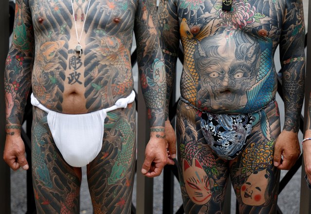 Participants wearing loincloth pose showing traditional Japanese tattoos during the Sanja Matsuri festival in Tokyo, Japan, 18 May 2025. The Sanja Matsuri, a three-day annual festival, is one of Tokyo’s most popular festivals and draws approximately two million visitors. (Photo by Franck Robichon/EPA/EFE)