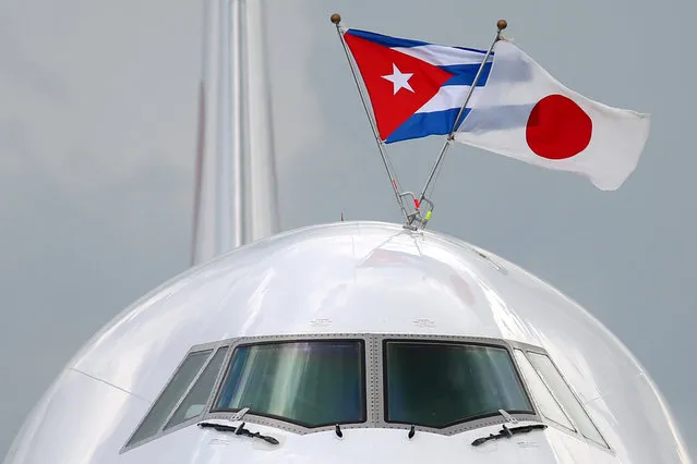 Cuban and Japanese flags are displayed on top of the airplane bringing Japan's Prime Minister Shinzo Abe upon his arrival at the Jose Marti International Airport in Havana, Cuba, September 22, 2016. (Photo by Alexandre Meneghini/Reuters)