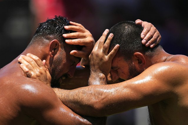 Wrestlers compete during the 664th annual Historic Kirkpinar Oil Wrestling championship, in Edirne, northwestern Turkey, Saturday, July 5, 2025. (Photo by Khalil Hamra/AP Photo)