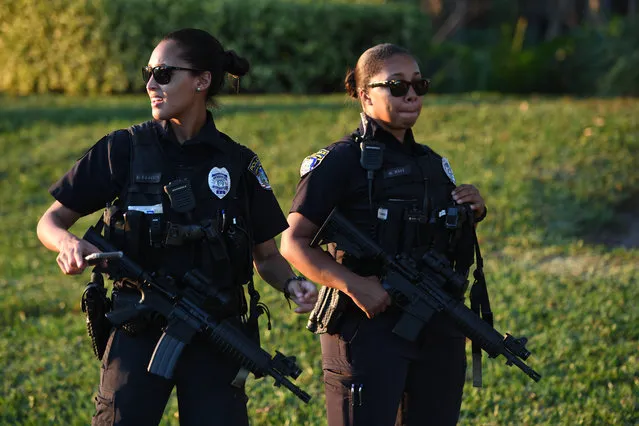 Armed police officers patrol the area around the Marjory Stoneman Douglas High School following a mass shooting in Parkland, Florida on February 14, 2018. (Photo by Larry Marano/Rex Features/Shutterstock)