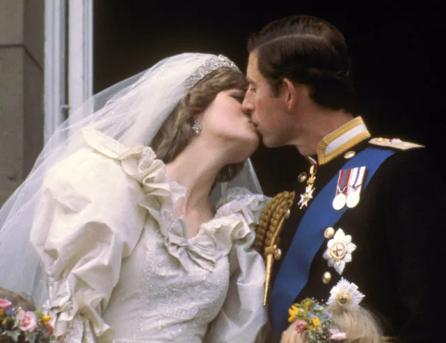 Britain's Prince Charles kisses his bride, the former Diana Spencer, on the balcony of Buckingham Palace in London, after their wedding on July 29, 1981. (Photo by AP Photo)
