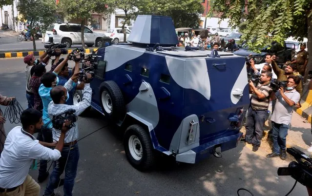 Video journalists film an armored vehicle carrying Abid Malhi, a key assailant suspected in the gang rape of a woman on a desolate highway, following his court appearance in Lahore, Pakistan, Tuesday, October 13, 2020. Police arrested a key suspect in a brutal rape of a woman whose car broke down on a deserted highway major highway near the eastern city of Lahore last month. (Photo by K.M. Chaudary/AP Photo)