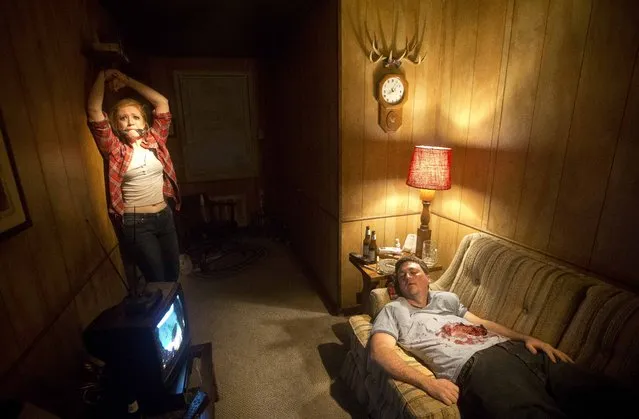 Actors Ben Brotzman and Kali McMillian recreate a scene from the AMC television show "The Walking Dead" for visitors to the "Walking Dead- Experience Chapter 1" Friday, October 30, 2015, in Atlanta.  "The Walking Dead Experience-Chapter 1" drops small groups of audience members into more than 10,000 square feet of sets and special effects designed to emulate the fear and chaos of the television show, organizers say. (Photo by John Bazemore/AP Photo)