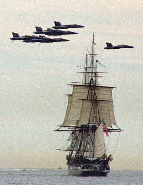 U.S. Navy Blue Angels perform a flyover above the USS Constitution during its first sail in over 116 years in Marblehead Harbor in Marblehead, Mass., Monday, July 21, 1997. (Photo by Victoria Arocho/AP Photo)