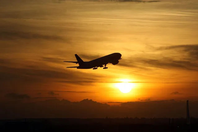 A plane taking off from Heathrow Airport at sunset, on November 19, 2008. Heathrow revealed the measure as part of a package designed to reduce the impact of expansion on the local community and the environment. (Photo by Steve Parsons/PA Wire)