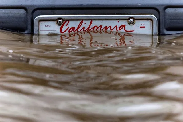 A California plate is seen at an area affected by floods after days of heavy rain in Pajaro, California, U.S., March 14, 2023. (Photo by Carlos Barria/Reuters)