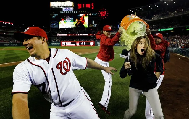 Washington Nationals starting pitcher Jordan Zimmermann dodges the Gatorade, but MASN's sideline reporter Julie Alexandria wasn't so lucky as relief pitchers Drew Storen and Ryan Mattheus pour the power drink after Zimmermann threw a one hit complete game shutout and the Nationals beat the Cincinnati Reds 1-0 at Nationals Park in Washington, on April 26, 2013. (Photo by Alex Brandon/Associated Press)