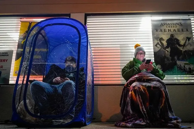 Shoppers wait in line eight hours prior to the opening, in hopes of Black Friday savings, at a computer game store in La Grange, Kentucky, U.S. November 26, 2020. (Photo by Bryan Woolston/Reuters)