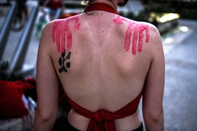 A person poses showing handprints on her shoulders as activists and sеx workers participate in a “sl*t Walk” in Miami beach, Florida on December 5, 2020. Activists and s*x workers marched in the streets of Miami Beach for the decriminalisation of s*x work. “This sl*t walk is an action created to ensure the rights of humans that chose to or are forced into sеx work. They are disproportionately persecuted and various intersectional identities compound this. The decriminalisation of sеx work will make a safer world for all of us and create a healthier more prosperous world”, said human rights activist Jonni Quest. (Photo by Chandan Khanna/AFP Photo)