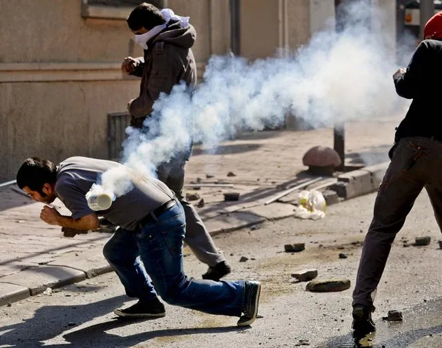 Clashes erupt between police and protesters during May Day celebrations in Istanbul, Turkey, on May 1, 2013. Police fired tear gas to disperse hundreds of demonstrators trying to break through barricades to access Istanbul's Taksim Square which the government banned a rally on the square which is undergoing major renovations. (Photo by Associated Press)