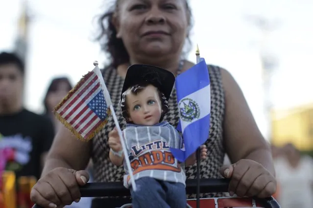 A Catholic faithful holds a figurine of baby Jesus during a religious procession on Holy Innocents Day in Antiguo Cuscatlan, on the outskirts of San Salvador, December 28, 2014. (Photo by Jose Cabezas/Reuters)