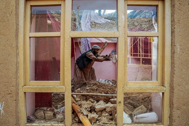 An Afghan man clears rubble from his damaged house, in the aftermath of an earthquake at a village in the Khulm district of Samangan province on November 4, 2025. An earthquake of 6.3-magnitude in northern Afghanistan has killed at least 27 people and injured nearly 1,000, the health ministry said on November 4, announcing the end of rescue operations. (Photo by AFP Photo/Stringer)