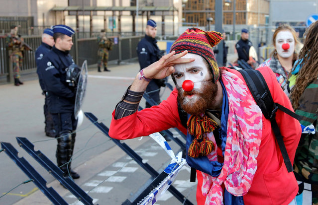 A demonstrator dressed as a clown performs during a protest against the Comprehensive Economic and Trade Agreement (CETA), a EU-Canada free trade agreement, outside the European Council in Brussels, Belgium, October 30, 2016. (Photo by Francois Lenoir/Reuters)