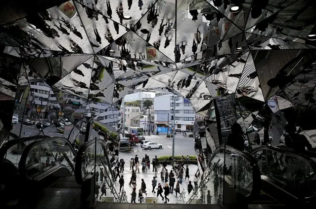 People are reflected in mirrors at an entrance to a department store in Tokyo, Japan, in this November 11, 2015 file photo. Japan is expected to report restail sales adat this week. (Photo by Toru Hanai/Reuters)