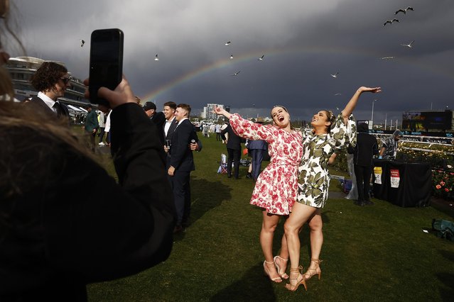 Racegoers pose for a photograph during 2022 Lexus Melbourne Cup Day at Flemington Racecourse on November 01, 2022 in Melbourne, Australia. (Photo by Daniel Pockett/Getty Images)