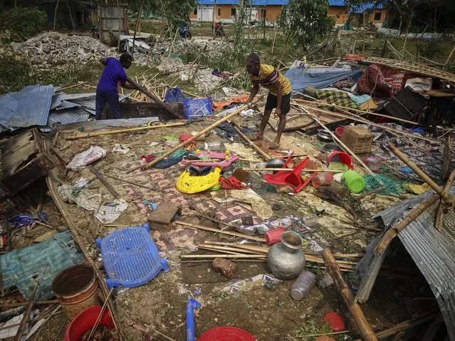 People salvage belongings from their homes damaged by Cyclone Mocha at Saint Martin island in Cox's Bazar, Bangladesh, Monday, May 15, 2023. (Photo by Al-emrun Garjon/AP Photo)