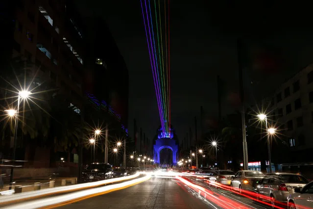 Rainbow-colored laser lights projected from the Revolution Monument across the city center  is pictured during the International Festival of Lights in Mexico City, Mexico November 11, 2016. (Photo by Carlos Jasso/Reuters)