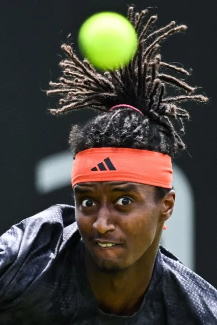 Sweden's Mikael Ymer eyes the ball as he returns it to Netherlands' Botic Van De Zandschulp during their men's singles round of 32 tennis match at the Rothesay Eastbourne International tennis tournament in Eastbourne, southern England, on June 27, 2023. (Photo by Glyn Kirk/AFP Photo)
