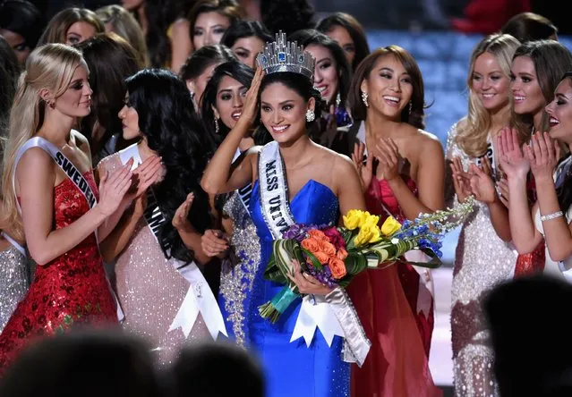 Miss Philippines 2015, Pia Alonzo Wurtzbach (C), who was mistakenly named as First Runner-up reacts with other contestants after being named the 2015 Miss Universe during the 2015 Miss Universe Pageant at The Axis at Planet Hollywood Resort & Casino on December 20, 2015 in Las Vegas, Nevada. (Photo by Ethan Miller/Getty Images)