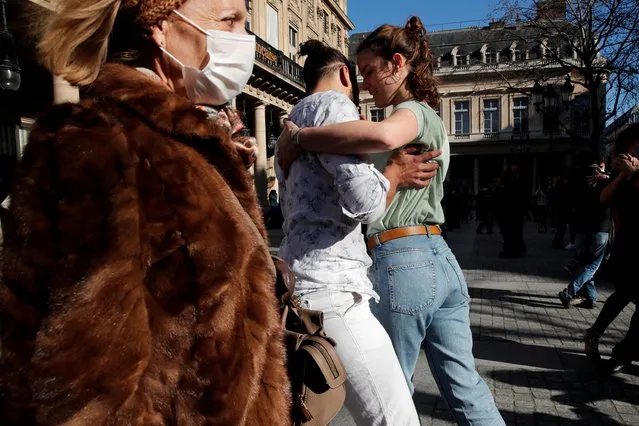 Tango aficionados meet up in front of the Comedie Francaise, Place Colette, amid the coronavirus disease (COVID-19) outbreak, in Paris, France, February 28, 2021. (Photo by Benoit Tessier/Reuters)