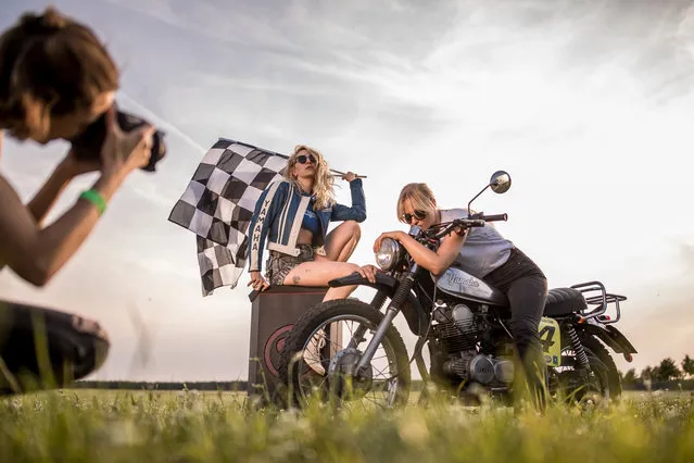 Members of Petrolettes pose for a photographer at the women's-only Petrolettes motorcycle festival on July 20, 2018 in Milmersdorf, near Berlin in Germany. Around 300 bike women from across Europe come together for the third edition of the festival. Women connect their passion for high speed motorbikes with music, movies, races, yoga etc. Festival that goes for three days was initiated by a group of female motorbike riders called The Curves. (Photo by Maja Hitij/Getty Images)