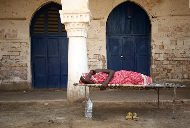 A man sleeps outdoors in the port city of Massawa, Eritrea on July 23, 2018. (Photo by Tiksa Negeri/Reuters)