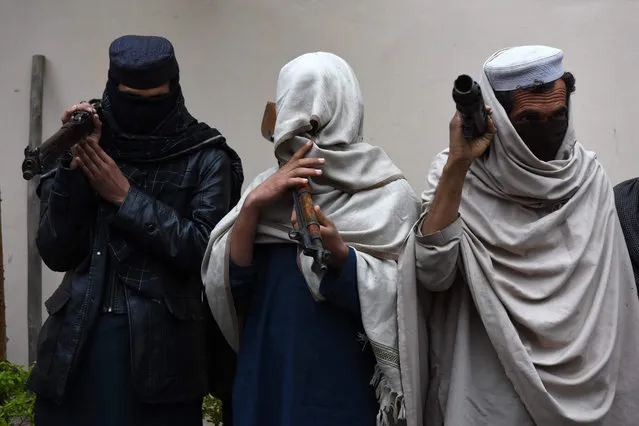 Former Taliban militants surrender their weapons during a reconciliation ceremony in Jalalabad, Afghanistan, 12 January 2016. The group of former Taliban militants laid down their arms in Jalalabad and joined the peace process. Under an amnesty launched by the former President Hamid Karzai and backed by the US in November 2004, hundreds of anti-government militants have so far surrendered to government. (Photo by Ghulamullah Habibi/EPA)