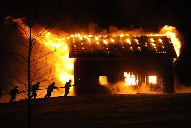 In this photo taken Wednesday evening, January 13, 2016, firefighters battle a garage fire on Perry Road in Pavilion, N.Y. The structure was completely destroyed. (Photo by Mark Gutman/The Daily News via AP Photo)
