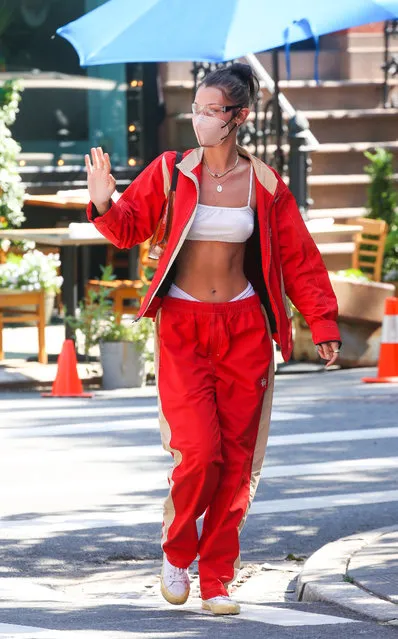 Bella Hadid is spotted stepping in New York City on June 5, 2021. The 24 year old American model stuck a pose in a midriff bearding crop top under a red and white tracksuit as she waved to friends and fans as she made her way down the street in trendy Soho New York. (Photo by The Image Direct)