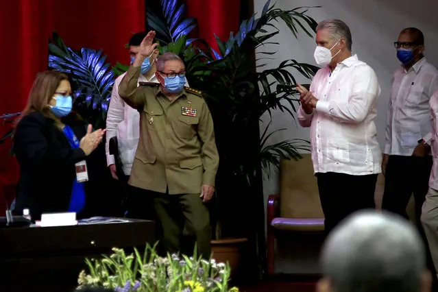Raul Castro, first secretary of the Communist Party and former president, waves to members at the VIII Congress of the Communist Party of Cuba's opening session, as Cuban President Miguel Diaz-Canel, right, applauds at the Convention Palace, in Havana, Cuba, Friday, April 16, 2021. (Photo by Ariel Ley Royero/ACN via AP Photo)