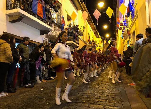 Crowds and marching bands gather for a nighttime parade in the city’s La Ronda section, part of the city’s historic center, commemorating the anniversary of the city’s founding by Spaniards, in Quito, Ecuador, December 6, 2018. (Photo by Will Dunham/Reuters)