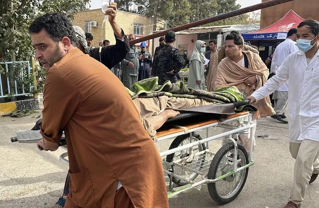 In this handout photo released by MSF Afghanistan, injured people received treatment after a powerful earthquake in Herat province, western of Afghanistan, Sunday, October 15, 2023. (Photo by MSF Afghanistan via AP Photo)
