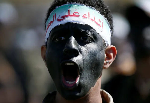 Newly recruited Houthi fighter shouts slogans as he takes part in a parade before heading to the frontline to fight against government forces, in Sanaa, Yemen January 4, 2017. The headband reads: “We are tough on infidles”. (Photo by Khaled Abdullah/Reuters)