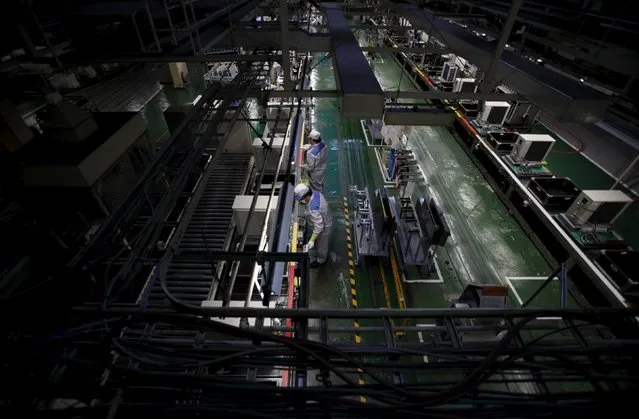 Daikin Industries Ltd employees work the production line of outdoor air conditioning units at the company's Kusatsu factory in Shiga prefecture, western Japan March 20, 2015. (Photo by Yuya Shino/Reuters)