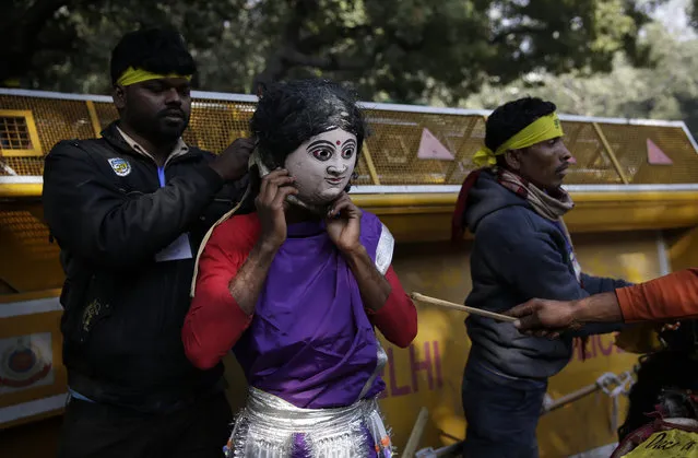 A member of India's Kudumi community wears a mask during a protest in New Delhi, India, Tuesday, December 18, 2018. They were demanding tribal status be reinstated for their community, which had been withdrawn by the Indian government in 1950. (Photo by Altaf Qadri/AP Photo)