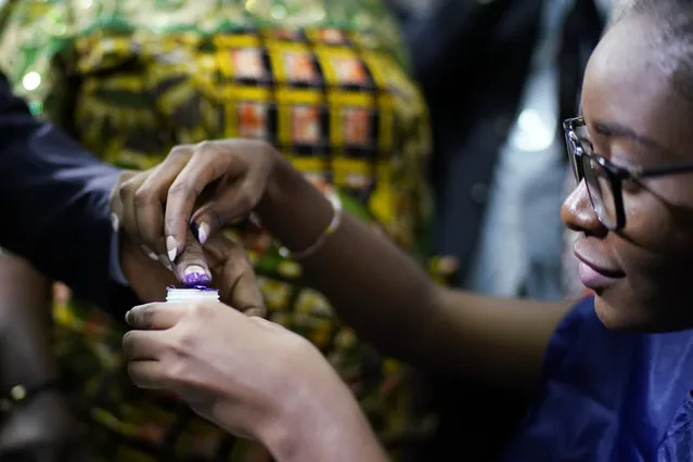Congolese President Joseph Kabila gets his finger inked after casting his vote Sunday, December 30, 2018 in Kinshasa, Congo. Forty million voters are registered for a presidential race plagued by years of delay and persistent rumors of lack of preparation. (Photo by Jerome Delay/AP Photo)