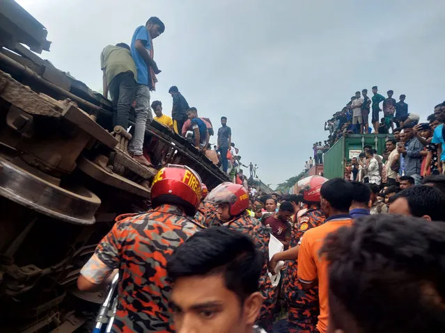 This photograph provided by the Bangladesh Fire Service and Civil Defense Department shows rescuers and others after a cargo train hit a passenger train at Bhairab, Kishoreganj district, Bangladesh, Monday, October 23, 2023. More than a dozen people are killed and scores more are injured according to fire officials. (Photo by Bangladesh Fire Service and Civil Defense Department via AP Photo)